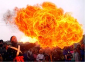 India - In Jammu, a flower of flame blooms from a man's kerosene-filled mouth