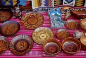Vender stalls sell carved and decorated Andean plates in Aguas Calientes, Peru