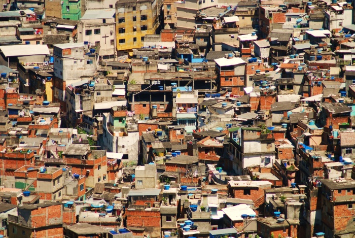 
	Rio de Janeiro's favela
	

	Now that Rio de Janeiro has won its bid to host the 2016 summer Olympics, it will be interesting to see what happens to the 1.3 million impoverished people who live in the over 750 favelas on the hills surrounding the city.
	
	Favelas are essentially slums or shanty towns (“favela” translates into “slum” in Brasilian Portuguese) set up in the suburbs of a city by by the poor who have no other means of shelter. They have existed since the late 1800s after former African slaves were ‘freed’ but had no rights to land ownership, means of education, or means of employment. Poor and with no rights or place to go, they started setting up shacks in rural areas and over the years moved closer and closer to the cities in an effort to find work. Now, Rio de Janeiro has the second greatest number of favelas in Brasil after Sao Paulo — 612 for Sao Paulo and 513 for Rio based on the 2000 Brasilian census, although the number for Rio is now over 750. Nineteen percent of Rio’s population lives in favelas and the population growth in favelas is higher than the population growth of Brasil as a whole.
	
	Various governments throughout Brazil’s history have attempted to remove the favelas, beginning in the 1940s when many of them were destroyed in favour of public housing. When the public housing was not delivered, the favelas essentially went right back up on the grounds from which they were originally cleared. Again in the 1950s the government attempted to ‘clean up’ the favelas by building two large apartment complexes, which did not solve the problem of the need for favelas. In the 1970s, while under military dictatorship, the government once again tried to destroy the favelas and move their inhabitants to public housing. However, the poor could not afford even public housing, and so the favelas persisted.

	Source: http://writerchick99.wordpress.com/2009/10/07/poor-people-make-way-for-sports/