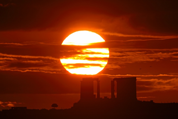 
	December Sunrise, Cape Sounion
	Astronomy Picture of the Day - 2009 December 23
	Credit & Copyright: Anthony Ayiomamitis (TWAN)
	
	Explanation: The Sun is a moving target. Its annual motion through planet Earth's sky tracks north and south, from solstice to solstice, as the seasons change. On December 21st, the solstice marking the first day of winter in the northern hemisphere and summer in the south, the Sun rose at its southernmost point along the eastern horizon. Earlier this month, looking toward the Aegean Sea from a well-chosen vantage point at Cape Sounion, Greece, it also rose in this dramatic scene. In the foreground lies the twenty-four hundred year old Temple of Poseidon.