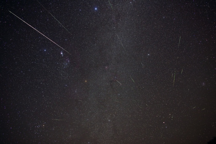 
	Southern Geminids
	Astronomy Picture of the Day - 2009 December 18
	Credit & Copyright: Phil Hart
	
	Explanation: At least 34 meteors are included in this composite image as they rain through Australian skies during the annual Geminid Meteor shower. Dust particles strung out along the orbit of extinct comet Phaethon vaporize when they plow through planet Earth's atmosphere causing the impressive display. Although the particles are traveling parallel to each other, the resulting streaks clearly seem to radiate from a single point on the sky near Gemini's twin stars Castor and Pollux at the lower right. The radiant effect is due to perspective, as the parallel tracks appear to converge at a distance. Taken over a period of 2 hours on the morning of December 14, short exposures recording individual meteor streaks were combined with a single long exposure to show the background stars, with Sirius at the top, and the constellation Orion at left. Faint stars and nebulae of the Milky Way track through the center of the frame. Near the radiant point, an extra star in Gemini is actually the flash of a meteor seen almost head-on.