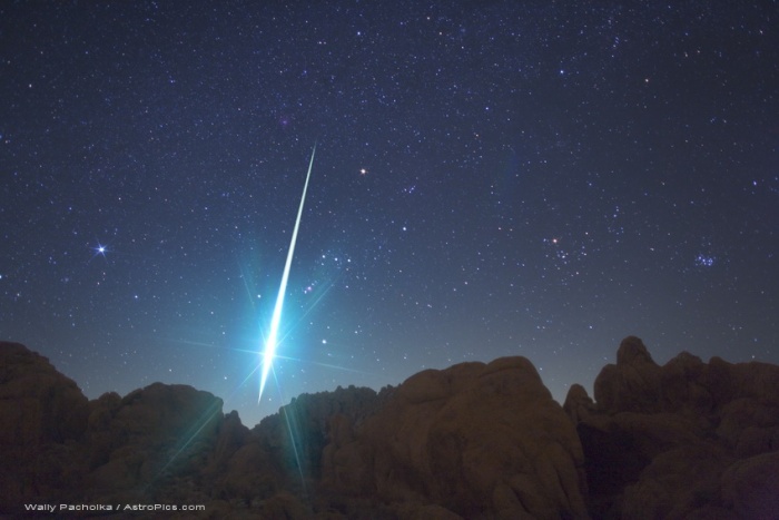 
	Mojave Desert Fireball
	Astronomy Picture of the Day - 2009 December 17
	Credit & Copyright: Wally Pacholka (AstroPics.com, TWAN)
	
	Explanation: Monstrously bright, this fireball meteor lit up the Mojave Desert sky Monday morning, part of this year's impressive Geminid meteor shower. Seen toward the southwest over rock formations near Victorville, California, a more familiar celestial background was momentarily washed out by the meteor's flash. The background includes bright star Sirius at the left, and Aldebaran and the Pleaides star cluster at the right side of the image. The meteor itself blazes through the constellation Orion. Its greenish trail begins just left of a yellow-tinted Betelgeuse and points back to the shower's radiant in Gemini, just off the top of the frame. A rewarding catch for photographer Wally Pacholka, the spectacular image is one of over 1500 frames that he reports captured 48, mostly faint, Geminid meteors.