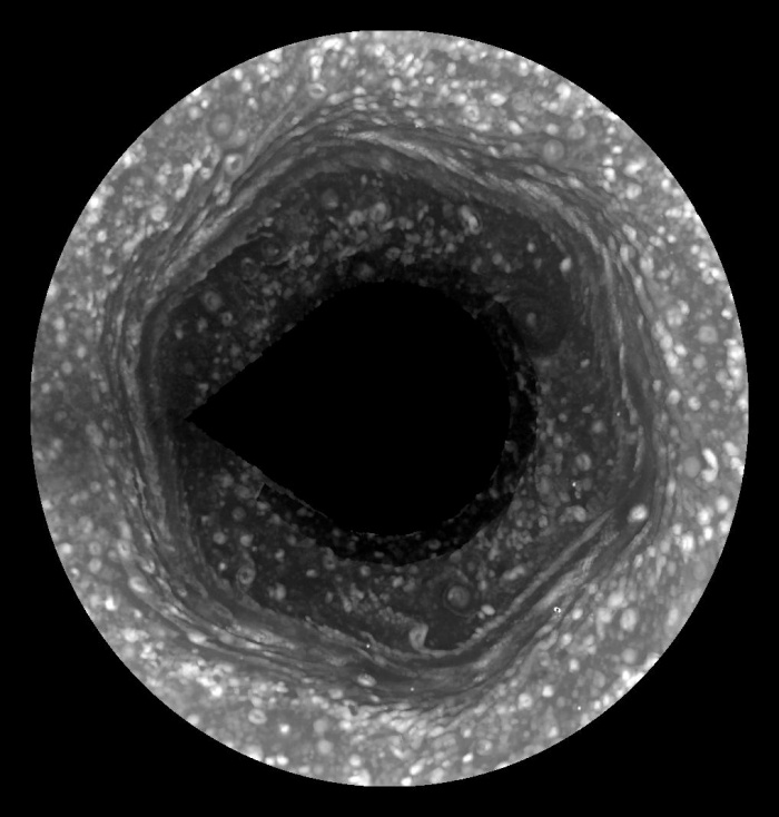 
	Saturns Hexagon Comes to Light
	Astronomy Picture of the Day - 2009 December 14
	Cassini Imaging Team, SSI, JPL, ESA, NASA
	
	Explanation: Believe it or not, this is the North Pole of Saturn. It is unclear how an unusual hexagonal cloud system that surrounds Saturn's north pole was created, keeps its shape, or how long it will last. Originally discovered during the Voyager flybys of Saturn in the 1980s, nobody has ever seen anything like it elsewhere in the Solar System. Although its infrared glow was visible previously to the Cassini spacecraft now orbiting Saturn, over the past year the mysterious hexagonal vortex became fully illuminated by sunlight for the first time during the Cassini's visit. Since then, Cassini has imaged the rotating hexagon in visible light enough times to create a time-lapse movie. The pole center was not well imaged and has been excluded. This movie shows many unexpected cloud motions, such as waves emanating from the corners of the hexagon. Planetary scientists are sure to continue to study this most unusual cloud formation for quite some time.