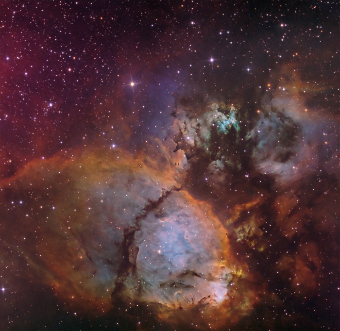 
	The Colors of IC 1795
	Astronomy Picture of the Day - 2009 December 10
	Credit & Copyright: Don Goldman
	
	Explanation: This colorful cosmic portrait features glowing gas and obscuring dust clouds in IC 1795, a star forming region in the northern constellation Cassiopeia. The nebula's colors were created by adopting the Hubble false-color palette for mapping narrow emission from oxygen, hydrogen, and sulfur atoms to blue, green and red colors, and further blending the data with images of the region recorded through broadband filters. Not far on the sky from the famous Double Star Cluster in Perseus, IC 1795 is itself located next to IC 1805, the Heart Nebula, as part of a complex of star forming regions that lie at the edge of a large molecular cloud. Located just over 6,000 light-years away, the larger star forming complex sprawls along the Perseus spiral arm of our Milky Way Galaxy. At that distance, this picture would span about 70 light-years across IC 1795.