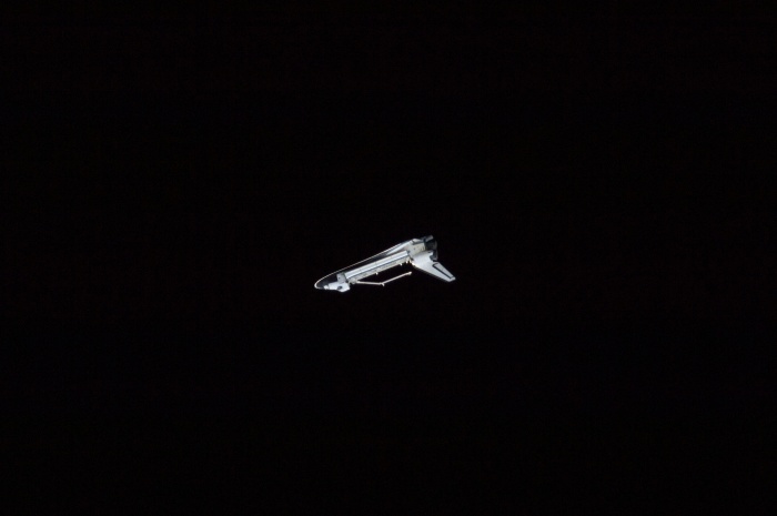 
	Space Shuttle Atlantis (STS-129) – undocked, upside down, robotic arm extended – surrounded by the blackness of Space
	November 25, 2009
	As seen from the International Space Station (Expedition 21)
	
	Credit: NASA