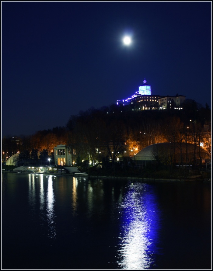 
	Not a Blue Moon
	Credit & Copyright: Stefano De Rosa
	Astronomy Picture of the Day - 2010 January 1
	
	Explanation: This bright Full Moon was captured on December 2nd, shining above a church overlooking the River Po, in Turin, Italy. It was the first Full Moon in December. Shining on celebrations of New Year's Eve, last night's Full Moon was the second Full Moon of December and so fits the modern definition of a Blue Moon - the second Full Moon in a month. Because the lunar cycle, Full Moon to Full Moon, spans 29.5 days, Blue Moons tend to occur in some month about every 2.5 years. Shining in the glare just above and right of December's first Full Moon is the Pleiades star cluster.