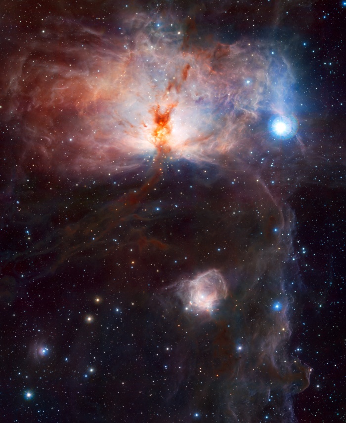 
	The Flame Nebula in Infrared
	Credit & Copyright: ESO/J. Emerson/VISTA; Acknowledgment: Cambridge Astronomical Survey Unit
	Astronomy Picture of the Day - 2010 January 12
	
	Explanation: What lights up the Flame Nebula? Fifteen hundred light years away towards the constellation of Orion lies a nebula which, from its glow and dark dust lanes, appears, on the left, like a billowing fire. But fire, the rapid acquisition of oxygen, is not what makes this Flame glow. Rather the bright star Alnitak, the easternmost star in the Belt of Orion visible just above the nebula, shines energetic light into the Flame that knocks electrons away from the great clouds of hydrogen gas that reside there. Much of the glow results when the electrons and ionized hydrogen recombine. The above false-color picture of the Flame Nebula (NGC 2024) was taken in infrared light, where a young star cluster becomes visible. The Flame Nebula is part of the Orion Molecular Cloud Complex, a star-forming region that includes the famous Horsehead Nebula, visible above on the far right.