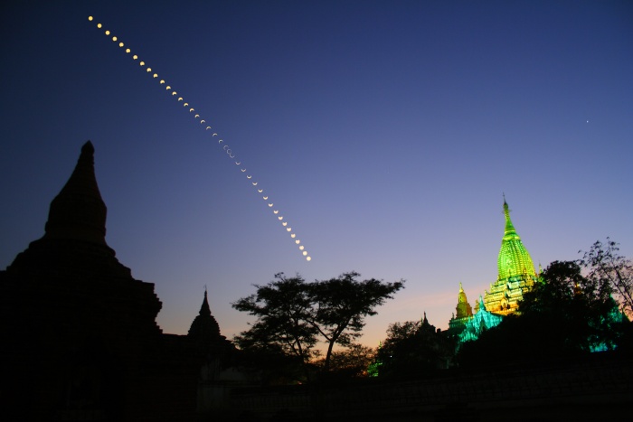 
	Annular Eclipse Over Myanmar
	Credit & Copyright: Wei Loon Chin
	Astronomy Picture of the Day - 2010 January 26
	
	Explanation: A hole crossed the Sun for a few minutes this month, as seen across a thin swath of planet Earth. The event on January 15 was actually an annular solar eclipse, and the hole was really Earth's Moon, an object whose dark half may appear even darker when compared to the tremendously bright Sun. The Moon was too far from Earth to create a total solar eclipse, but instead left well placed observers with a bright surrounding circle called the ring of fire. Pictured above was a complete solar annular eclipse sequence as seen above the Ananda Temple in Bagan, Myanmar. The image of the ancient temple, built around the year 1100, was taken after sunset on the same day of the eclipse. The next solar eclipse will be a total solar eclipse during 2010 July.
