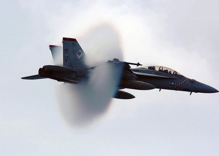 Somewhere over the Philippine Sea a US Navy (USN) F/A-18F Super Hornet, Strike Fighter Squadron 102 (VFA-102), Diamondbacks, Naval Air Station (NAS) Atsugi, Japan (JPN), breaks the sound barrier during a fly-by over the aircraft carrier USS KITTY HAWK (CV 63) [not shown].  Source: Wikipedia