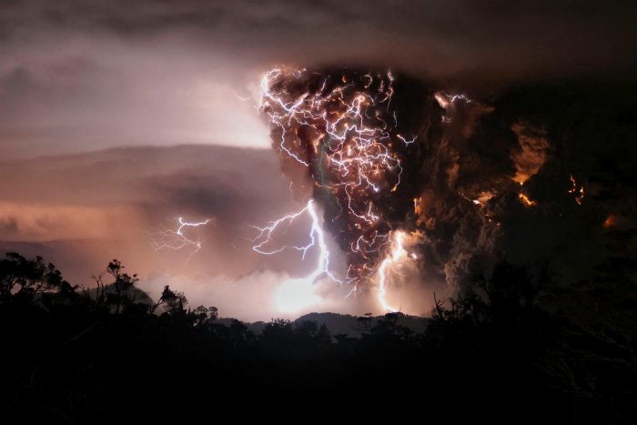 
	Lightning bolts appear above and around the Chaitén volcano in southern Chile as seen from Chana, some 30 kilometers north of the volcano. The mingling of lightning and ash is a so called dirty thunderstorm. These storms may be sparked when rock fragments, ash, and ice particles in the plume collide to produce static charges, just as ice particles collide to create charge in regular thunderstorms.
	
	Image Credit: Carlos Gutierrez/UPI/astroarts.org