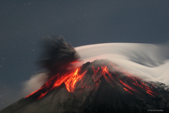 
	Tungurahua Erupts
	Credit & Copyright: Patrick Taschler
	Astronomy Picture of the Day: 2007 September 18
	
	Explanation: Volcano Tungurahua erupted spectacularly last year. Pictured above, molten rock so hot it glows visibly pours down the sides of the 5,000-meter high Tungurahua, while a cloud of dark ash is seen being ejected toward the left. Wispy white clouds flow around the lava-lit peak, while a star-lit sky shines in the distance. The above image was captured last year as ash fell around the adventurous photographer. Located in Ecuador, Tungurahua has become active roughly every 90 years since for the last 1,300 years. Volcano Tungurahua has started erupting again this year and continues erupting at a lower lever even today.