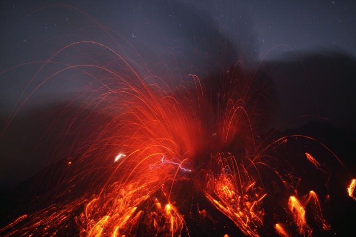 
	Sakurajima Volcano with Lightning
	Credit & Copyright: Martin Rietze (Alien Landscapes on Planet Earth)
	Astronomy Picture of the Day - 2010 February 10
	
	Explanation: Why does a volcanic eruption sometimes create lightning? Pictured above, the Sakurajima volcano in southern Japan was caught erupting early last month. Magma bubbles so hot they glow shoot away as liquid rock bursts through the Earth's surface from below. The above image is particularly notable, however, for the lightning bolts caught near the volcano's summit. Why lightning occurs even in common thunderstorms remains a topic of research, and the cause of volcanic lightning is even less clear. Surely, lightning bolts help quench areas of opposite but separated electric charges. One hypothesis holds that catapulting magma bubbles or volcanic ash are themselves electrically charged, and by their motion create these separated areas. Other volcanic lightning episodes may be facilitated by charge-inducing collisions in volcanic dust. Lightning is usually occurring somewhere on Earth, typically over 40 times each second.
