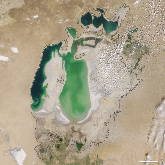 Aral sea in 2002 as seen by images from the Moderate Resolution Imaging Spectroradiometer (MODIS) on NASA’s Terra satellite. By 2001, the southern connection had been severed, and the shallower eastern part retreated rapidly over the next several years. As the lake dried up, fisheries and the communities that depended on them collapsed. The increasingly salty water became polluted with fertilizer and pesticides. The blowing dust from the exposed lakebed, contaminated with agricultural chemicals, became a public health hazard. The salty dust blew off the lakebed and settled onto fields, degrading the soil. Croplands had to be flushed with larger and larger volumes of river water. The loss of the moderating influence of such a large body of water made winters colder and summers hotter and drier. Photo and words: NASA