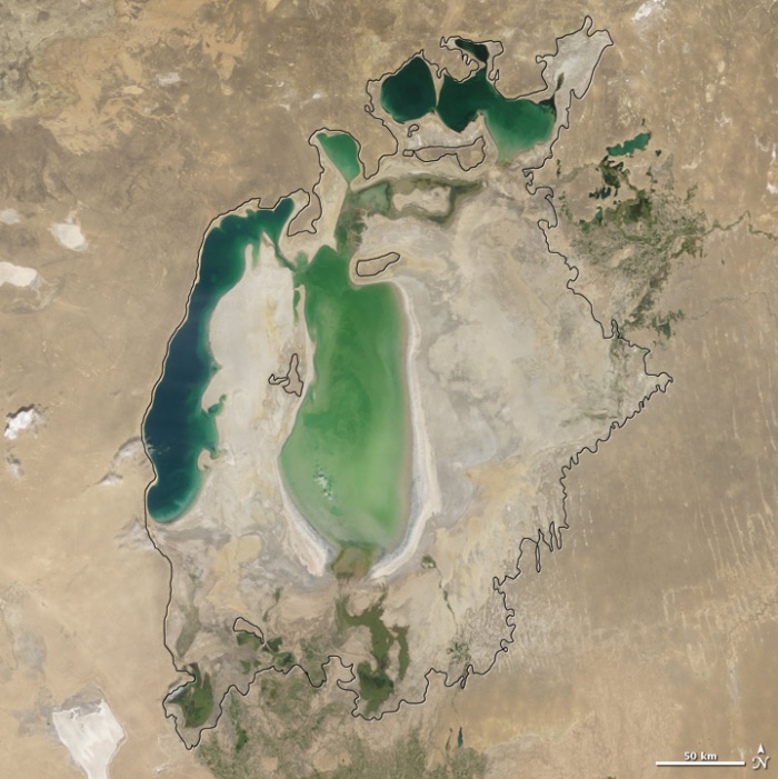 Aral sea in 2004 as seen by images from the Moderate Resolution Imaging Spectroradiometer (MODIS) on NASA’s Terra satellite. By 2001, the southern connection had been severed, and the shallower eastern part retreated rapidly over the next several years. As the lake dried up, fisheries and the communities that depended on them collapsed. The increasingly salty water became polluted with fertilizer and pesticides. The blowing dust from the exposed lakebed, contaminated with agricultural chemicals, became a public health hazard. The salty dust blew off the lakebed and settled onto fields, degrading the soil. Croplands had to be flushed with larger and larger volumes of river water. The loss of the moderating influence of such a large body of water made winters colder and summers hotter and drier. Photo and words: NASA