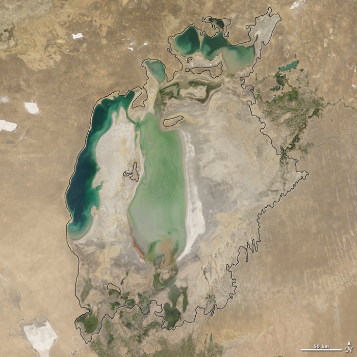 Aral sea in 2005 as seen by images from the Moderate Resolution Imaging Spectroradiometer (MODIS) on NASA’s Terra satellite. By 2001, the southern connection had been severed, and the shallower eastern part retreated rapidly over the next several years. As the lake dried up, fisheries and the communities that depended on them collapsed. The increasingly salty water became polluted with fertilizer and pesticides. The blowing dust from the exposed lakebed, contaminated with agricultural chemicals, became a public health hazard. The salty dust blew off the lakebed and settled onto fields, degrading the soil. Croplands had to be flushed with larger and larger volumes of river water. The loss of the moderating influence of such a large body of water made winters colder and summers hotter and drier. Photo and words: NASA