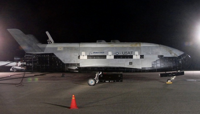 The X-37B sits on the Vandenberg Air Force Base runway during post-landing operations Dec. 3. The X-37B, named Orbital Test Vehicle 1 (OTV-1), conducted on-orbit experiments for more than 220 days during its maiden voyage. It fired its orbital maneuver engine in low-earth orbit to perform an autonomous reentry before landing.  Source: www.afspc.af.mil