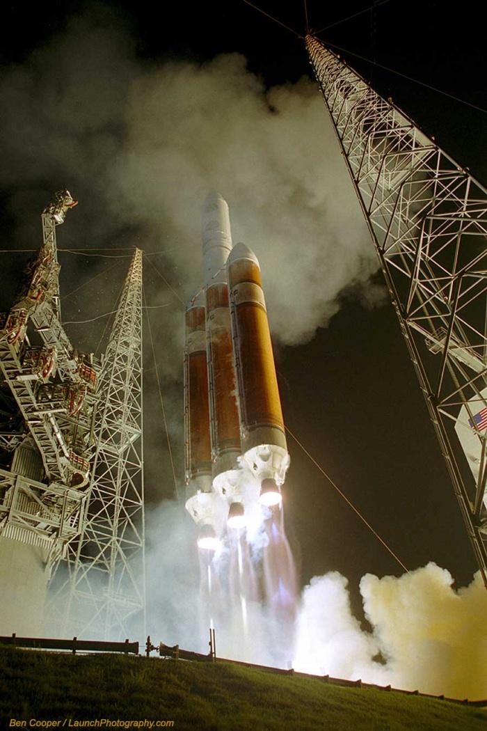 Launch of a Delta IV Heavy  Credit: Ben Cooper (Launch Photography)  Astronomy Picture of the Day - 2010 December 14  Explanation: It is the tallest rocket in active use. The Delta IV Heavy is the largest of the Delta series, packing the punch of three rocket boosters instead of the usual one. The resulting rocket, the most powerful in use by the US Air Force, is capable of lifting over 23,000 kilograms into low Earth orbit, comparable to NASA's Space Shuttle. Pictured above is the second launch of the Delta IV Heavy from Cape Canaveral, Florida, USA in 2007, and the first night launch. Complex service towers are visible to each side of the soaring rocket. The rocket successfully lifted a reconnaissance satellite to low Earth orbit. The Delta IV Heavy has since completed several more successful lift-offs, while its next launch is currently planned from Vandenberg Air Force Base, California, USA, next month.