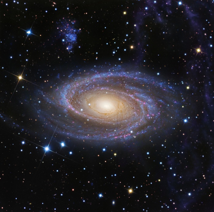    M81 and Arp's Loop  Credit:  R Jay GaBany - Collaboration: A. Sollima (IAC),  A. Gil de Paz (U. Complutense Madrid) D. Martínez-Delgado (IAC, MPIA), J.J. Gallego-Laborda (Fosca Nit Obs.), T. Hallas (Hallas Obs.) Astronomy Picture of the Day - 2010 December 9  Explanation: One of the brightest galaxies in planet Earth's sky and similar in size to the Milky Way, big, beautiful spiral M81 lies 11.8 million light-years away in the northern constellation Ursa Major. This deep image of the region reveals details in the bright yellow core, but at the same time follows fainter features along the galaxy's gorgeous blue spiral arms and sweeping dust lanes. It also follows the expansive, arcing feature, known as Arp's loop, that seems to rise from the galaxy's disk at the right. Studied in the 1960s, Arp's loop has been thought to be a tidal tail, material pulled out of M81 by gravitational interaction with its large neighboring galaxy M82. But a recent investigation demonstrates that much of Arp's loop likely lies within our own galaxy. The loop's colors in visible and infrared light match the colors of pervasive clouds of dust, relatively unexplored galactic cirrus only a few hundred light-years above the plane of the Milky Way. Along with the Milky Way's stars, the dust clouds lie in the foreground of this remarkable view. M81's dwarf companion galaxy, Holmberg IX, can be seen just above and left of the large spiral. On the sky, this image spans about 0.5 degrees, about the size of the Full Moon.