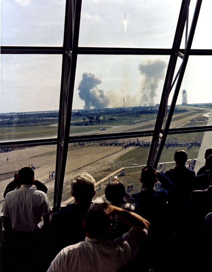 
	Launch team members view the Apollo 11 through the firing room windows.

	Source: NASA