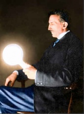 Tesla holding a gas-filled phosphor-coated light bulb