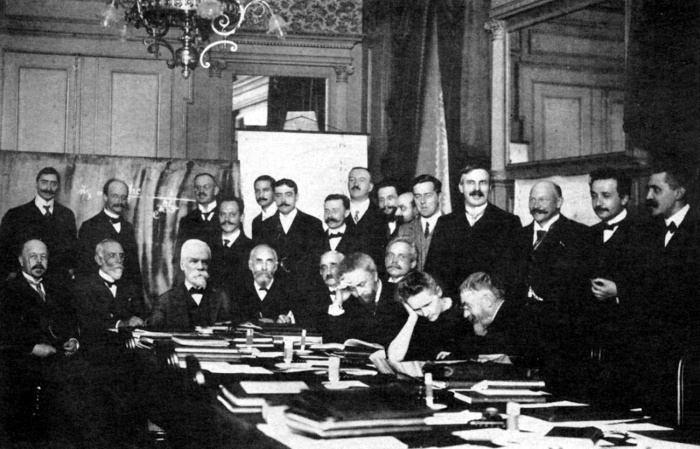 
	1911 First Solvay Conference on Physics
	
	Seated (L-R): Walther Nernst, Marcel Brillouin, Ernest Solvay, Hendrik Lorentz, Emil Warburg, Jean Baptiste Perrin, Wilhelm Wien, Marie Curie, and Henri Poincaré.
	Standing (L-R): Robert Goldschmidt, Max Planck, Heinrich Rubens, Arnold Sommerfeld, Frederick Lindemann, Maurice de Broglie, Martin Knudsen, Friedrich Hasenöhrl, Georges Hostelet, Edouard Herzen, James Hopwood Jeans, Ernest Rutherford, Heike Kamerlingh Onnes, Albert Einstein, and Paul Langevin.
	
	Photograph was taken by Benjamin Couprie, 1911, published not long afterwards. PD in USA because of age.

	Source: http://en.wikipedia.org/wiki/File:1911_Solvay_conference.jpg

	Ernest Solvay (1838-1922) was a Belgian chemist and industrialist whose patents brought him considerable wealth, which he used to bankroll several philanthropic endeavors. In 1894 he founded a sociology institute at the University of Brussels, called 