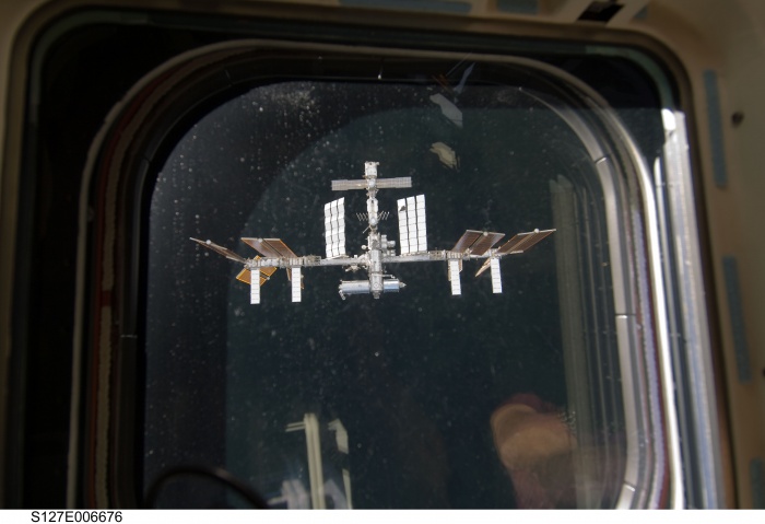 
	July 17, 2009 (Flight Day 3, ISS Docking)

	One of Endeavour's aft flight deck windows frames the nearby International Space Station.