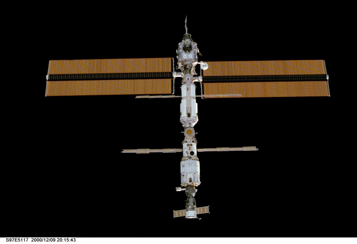 
	S97-E-5117 (9 December 2000) --- This is one of a series of digital still camera views showing the International Space Station (ISS) during a fly-around by the Space Shuttle Endeavour. The 240-foot-long, 38-foot-wide solar array (top) is the newest part and one of the most prominent components of the station. Onboard ISS were astronaut William M. Shepherd and cosmonauts Yuri P. Gidzenko and Sergei K. Krikalev. The Soyuz spacecraft which had taxied them to the station some 40 days ago is at the bottom of the complex, docked with the Zvezda Service Module. Onboard the shuttle were STS-97 astronauts -- commander Brent W. Jett, Jr., pilot Mike Bloomfield and mission specialists Marc Garneau of the Canadian Space Agency (CSA), Carlos I. Noriega and Joseph R. Tanner.
	
	Source: http://spaceflight.nasa.gov/gallery/images/station/assembly/ndxpage3.html
