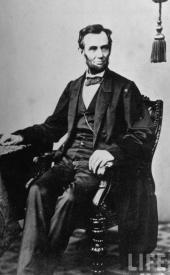 President Abraham Lincoln sitting in a chair (1864)